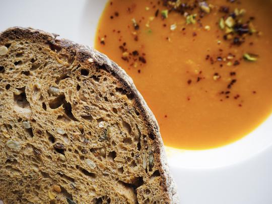 Carrot soup and toast close up by Jihane